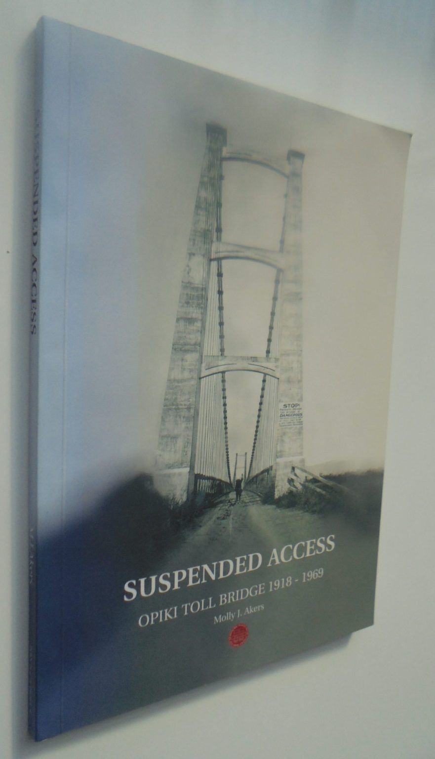 Suspended Access: The History of the Privately Owned Opiki Toll Bridge 1918-1969 by M.J. Akers. SIGNED BY AUTHOR.